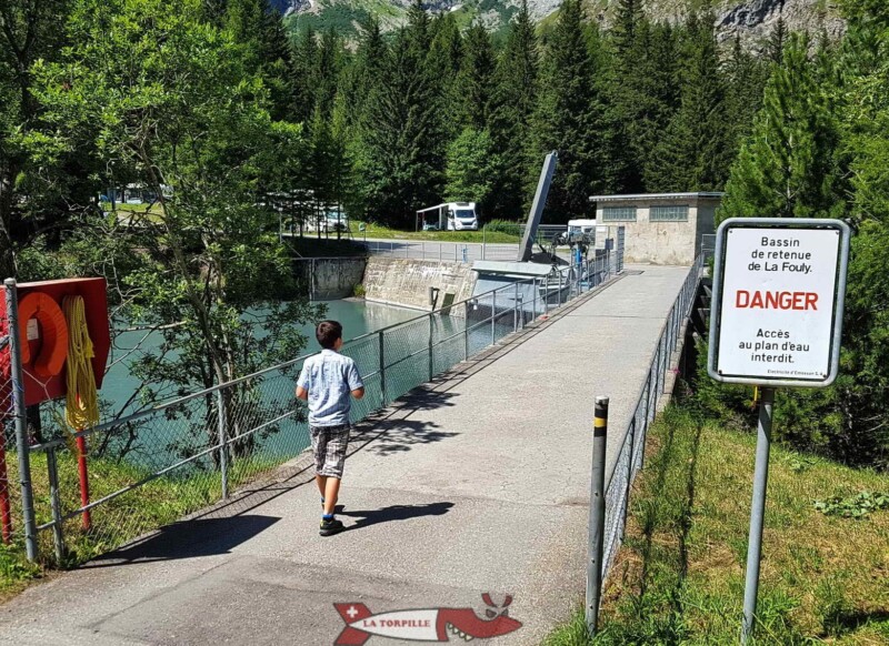 Le chemin qui mène à l'accrobranche depuis le parking passe par la retenue d'eau. Le chemin qui mène à l'accrobranche depuis le parking passe par la retenue d'eau.