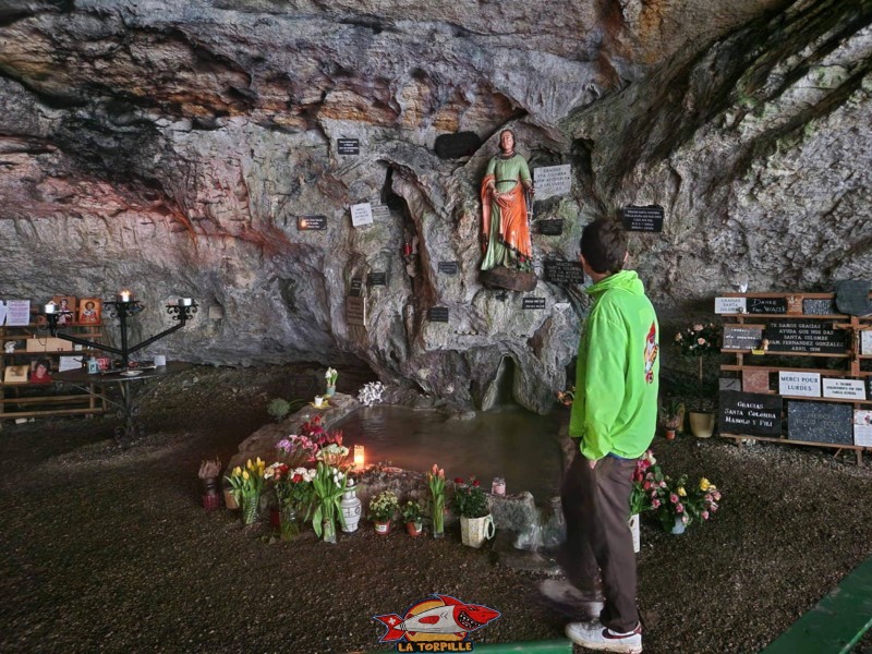 Sur la droite, des plaques en pierre ramenées par des pèlerins. Grotte de Sainte-Colombe