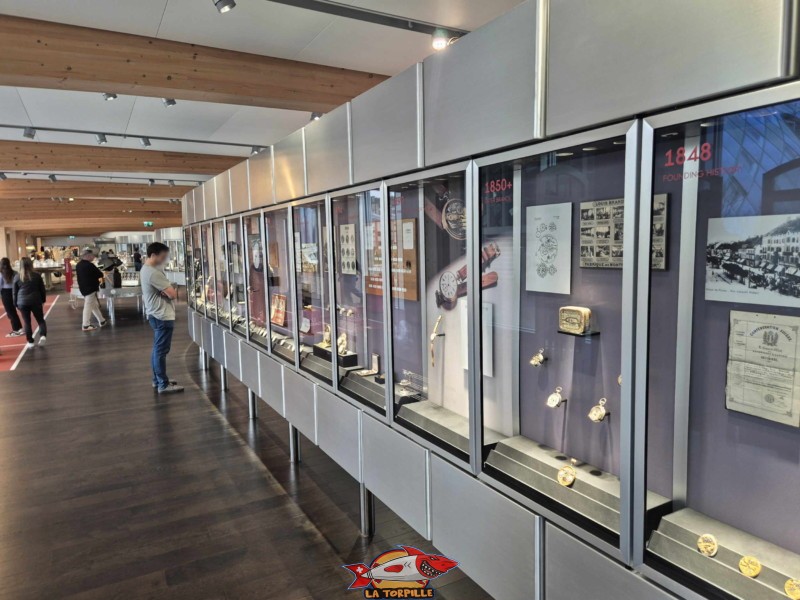 L'art horloger : On y trouve des montres historiques exposées dans une vitrine de 50 mètres de long, illustrant l'évolution du design et de la technologie d'Omega. Omega Museum, Bienne.