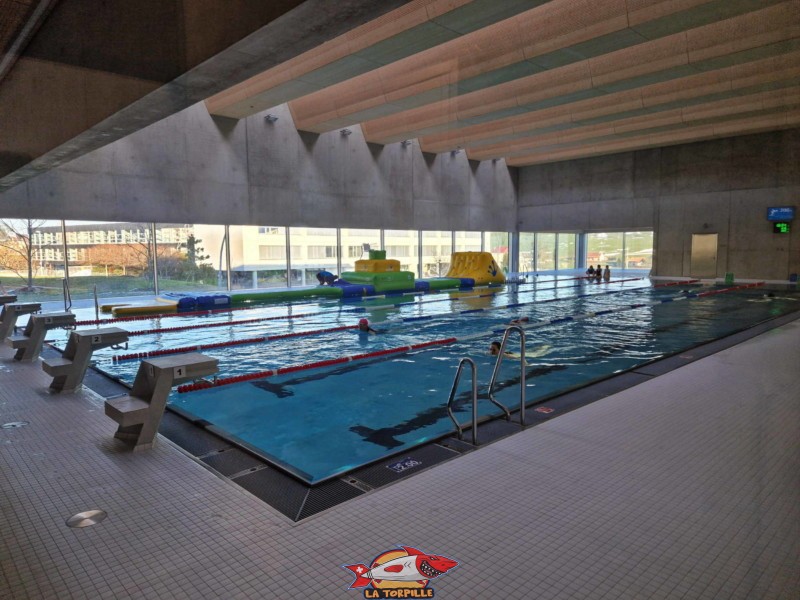 La piscine couverte de l'Epicentre avec le bassin nageur et une structure de jeu flottante pour les enfants.