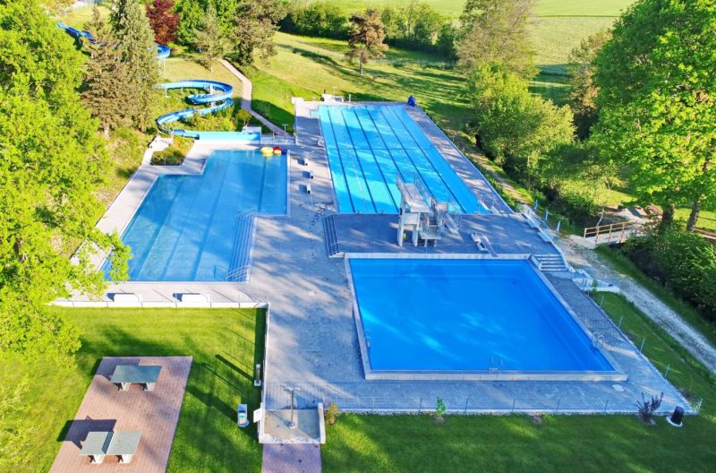 Les 3 bassins de la piscine de Kerzers avec le toboggan au fond à gauche.